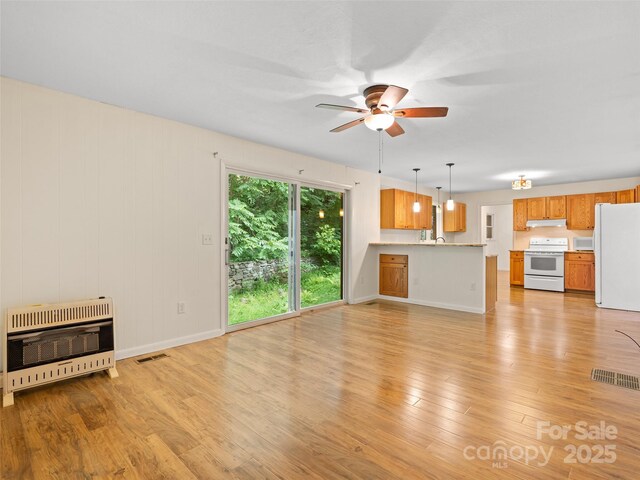 71 Auburn Park Dr, Waynesville, NC 28786 - unfurnished living room featuring heating unit, ceiling fan, and light wood finished floors