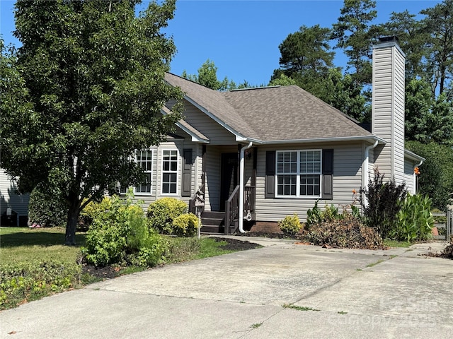 4870 Beckel Rd, Winston Salem, NC 27127 - view of front of home featuring a chimney and roof with shingles