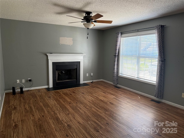 4870 Beckel Rd, Winston Salem, NC 27127 - unfurnished living room with ceiling fan, wood finished floors, a textured ceiling, and a fireplace with flush hearth
