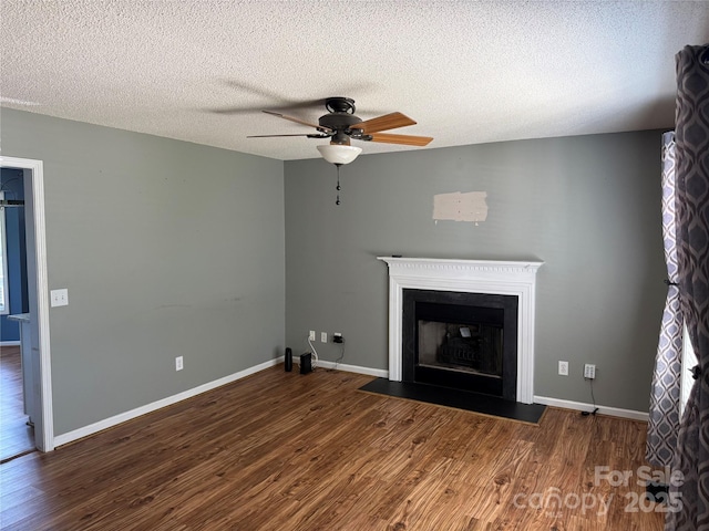 4870 Beckel Rd, Winston Salem, NC 27127 - unfurnished living room with ceiling fan, wood finished floors, a fireplace with flush hearth, and a textured ceiling