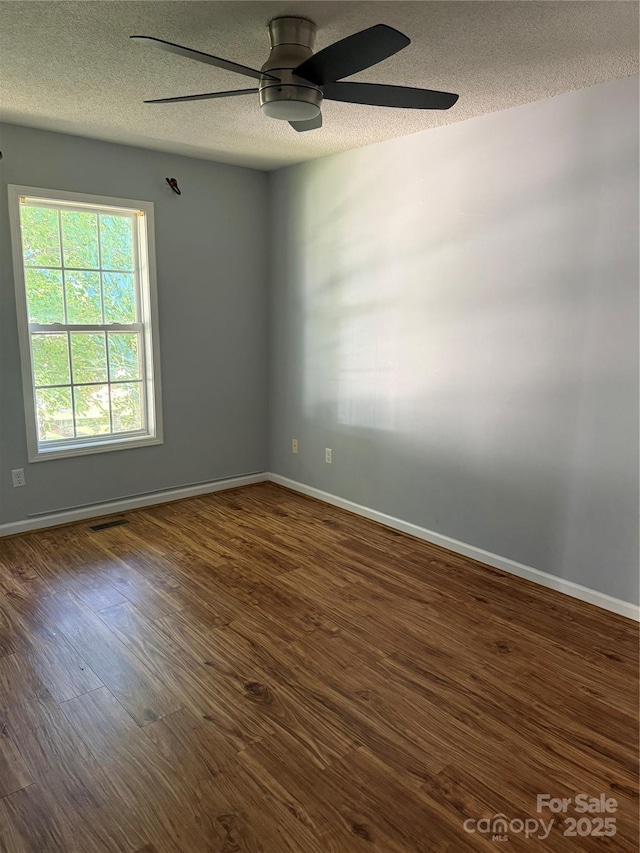 4870 Beckel Rd, Winston Salem, NC 27127 - spare room featuring a textured ceiling, a ceiling fan, and dark wood-type flooring