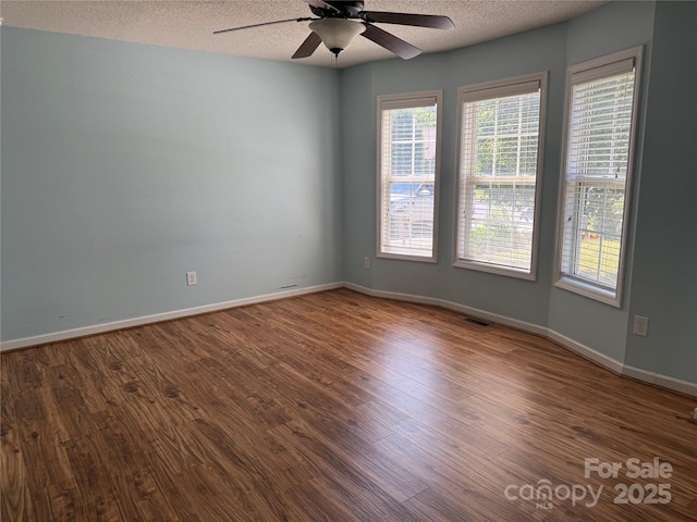 4870 Beckel Rd, Winston Salem, NC 27127 - spare room featuring ceiling fan, a textured ceiling, and wood finished floors
