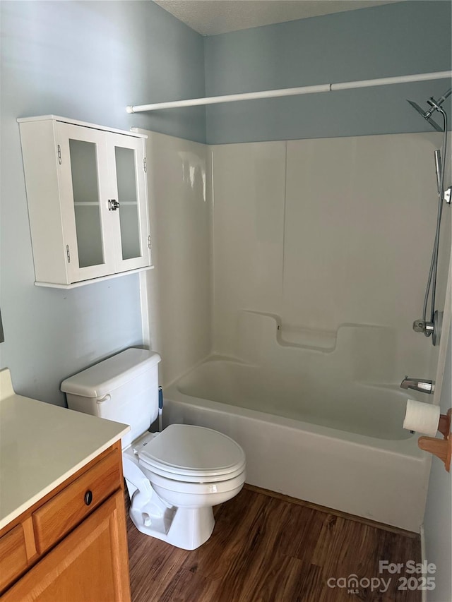 4870 Beckel Rd, Winston Salem, NC 27127 - bathroom featuring bathtub / shower combination, vanity, and wood finished floors