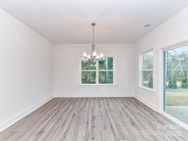 5613 Morgan Mill Rd, Monroe, NC 28110 - spare room with light wood-style floors, a chandelier, and healthy amount of natural light