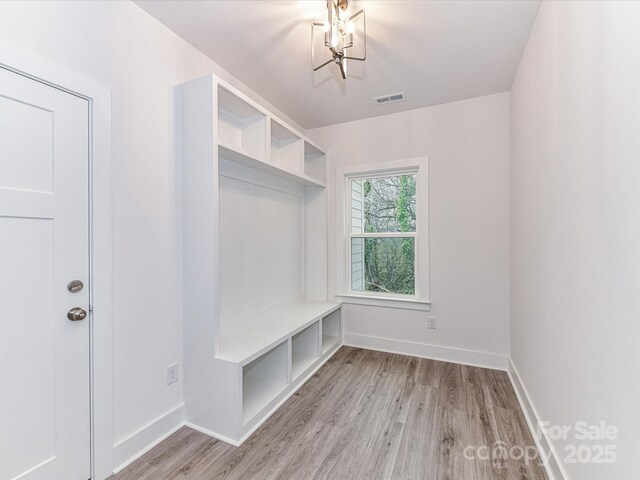 5613 Morgan Mill Rd, Monroe, NC 28110 - mudroom featuring light wood finished floors and a chandelier