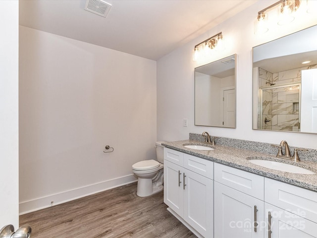 5613 Morgan Mill Rd, Monroe, NC 28110 - full bath featuring a shower stall, double vanity, and wood finished floors