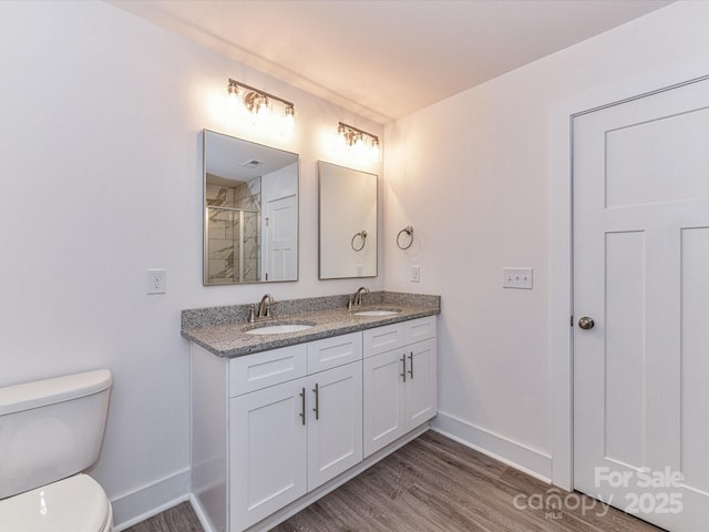 5613 Morgan Mill Rd, Monroe, NC 28110 - full bath with double vanity, wood finished floors, and a shower