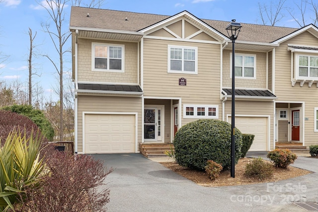 64 Foxden Dr Unit 201, Fletcher, NC 28732 - view of property featuring a garage, asphalt driveway, a standing seam roof, a shingled roof, and entry steps