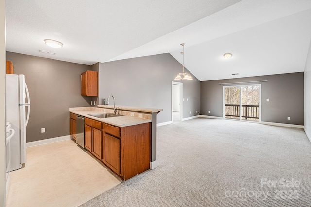 64 Foxden Dr Unit 201, Fletcher, NC 28732 - kitchen with freestanding refrigerator, brown cabinets, a peninsula, dishwasher, and vaulted ceiling