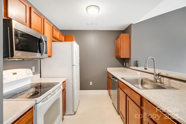 64 Foxden Dr Unit 201, Fletcher, NC 28732 - kitchen with appliances with stainless steel finishes, brown cabinetry, and light countertops
