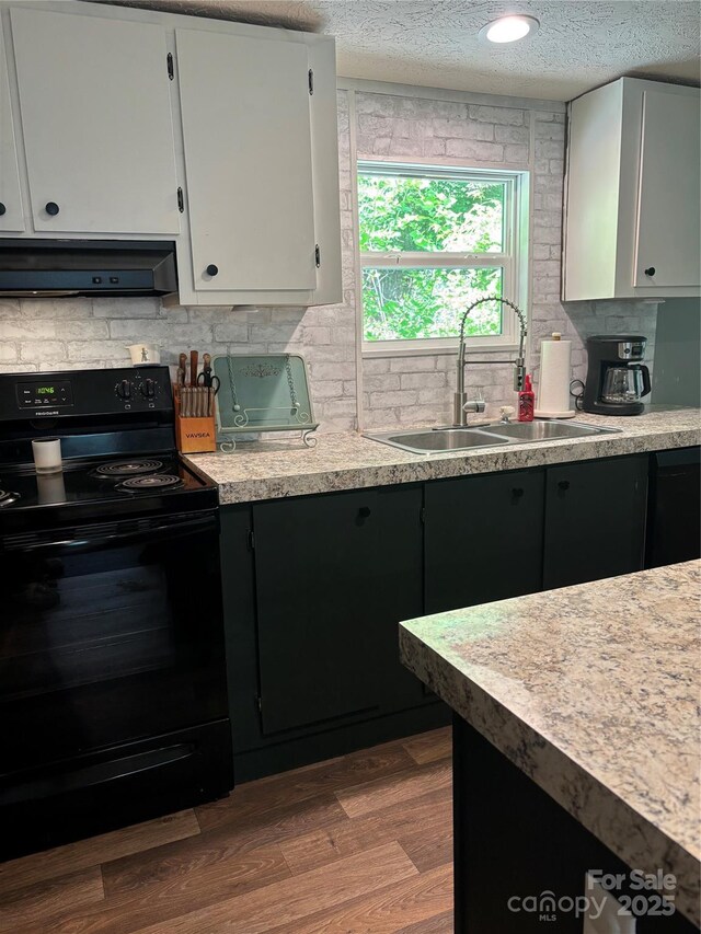 2877 Shannon St, Sharon, SC 29742 - kitchen featuring black / electric stove, exhaust hood, white cabinetry, light countertops, and a textured ceiling