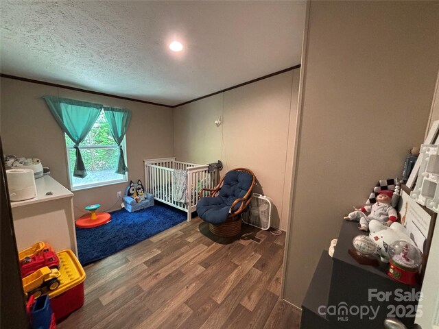 2877 Shannon St, Sharon, SC 29742 - bedroom featuring wood finished floors, a crib, crown molding, and a textured ceiling