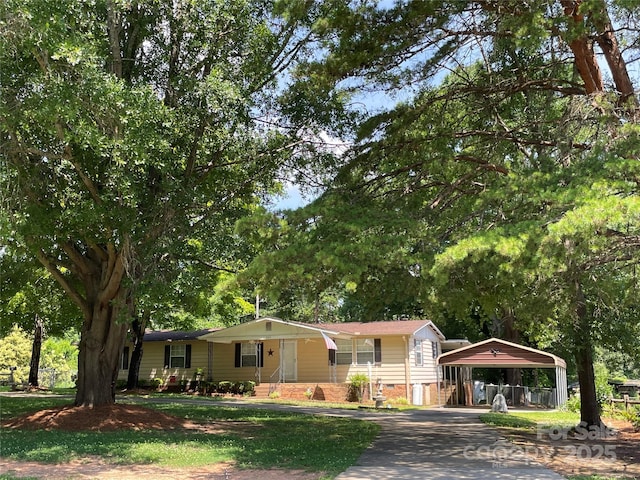 3403 Beaty Rd, Gastonia, NC 28056 - view of front of property featuring a detached carport, covered porch, driveway, and view of wooded area