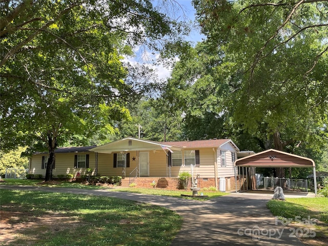 3403 Beaty Rd, Gastonia, NC 28056 - view of front facade featuring a carport, asphalt driveway, a front yard, view of wooded area, and crawl space