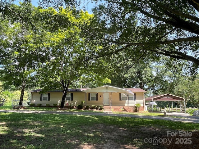 3403 Beaty Rd, Gastonia, NC 28056 - view of front facade featuring a detached carport, a front lawn, and brick siding