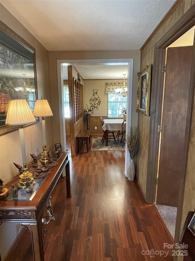3403 Beaty Rd, Gastonia, NC 28056 - hall featuring dark wood-style flooring, a textured ceiling, and a chandelier