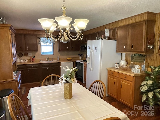 3403 Beaty Rd, Gastonia, NC 28056 - kitchen featuring white appliances, a chandelier, light countertops, and pendant lighting