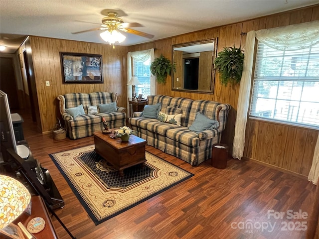3403 Beaty Rd, Gastonia, NC 28056 - living area featuring wood walls, healthy amount of natural light, ceiling fan, wood finished floors, and a textured ceiling