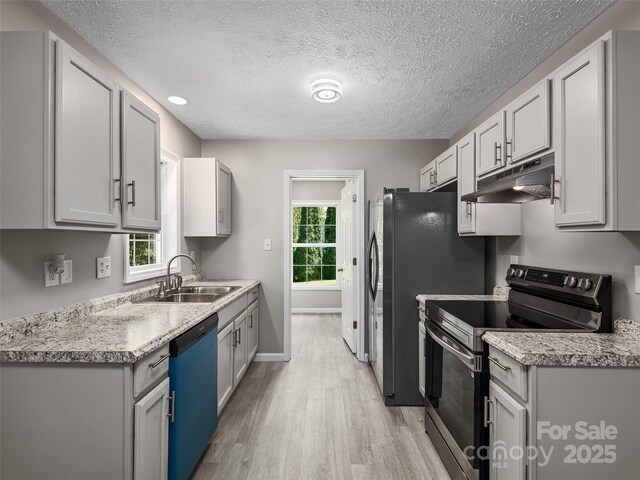 19 Cedar St, Canton, NC 28716 - kitchen featuring stainless steel electric range, dishwashing machine, under cabinet range hood, light wood-type flooring, and light countertops