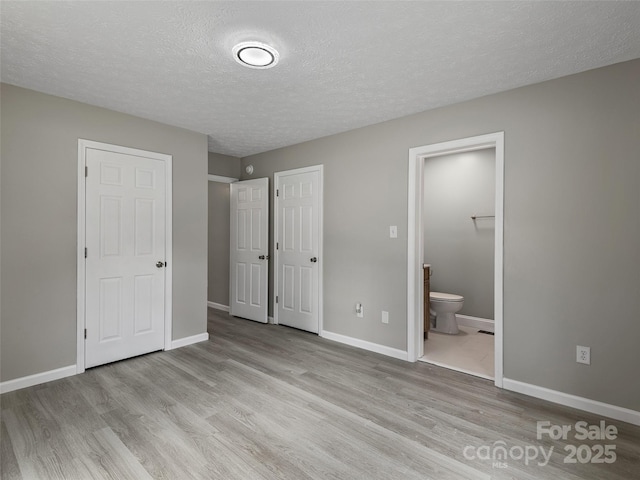 19 Cedar St, Canton, NC 28716 - unfurnished bedroom featuring wood finished floors, a textured ceiling, and ensuite bathroom