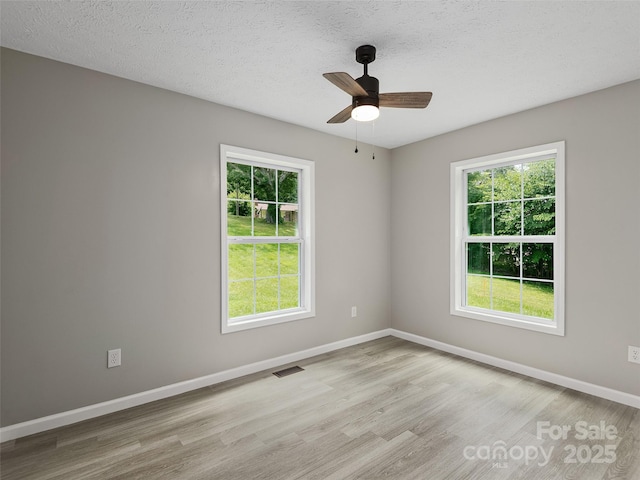 19 Cedar St, Canton, NC 28716 - spare room with healthy amount of natural light, wood finished floors, ceiling fan, and a textured ceiling