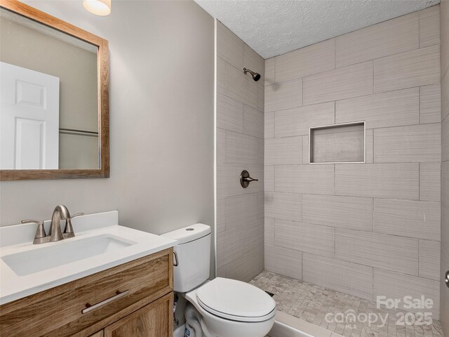 19 Cedar St, Canton, NC 28716 - full bath with a tile shower, vanity, and a textured ceiling