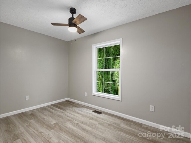 19 Cedar St, Canton, NC 28716 - spare room featuring light wood-style floors, a ceiling fan, and a textured ceiling