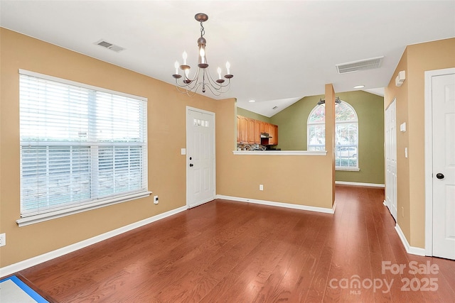 4580 Antelope Ln, Charlotte, NC 28269 - entryway featuring a chandelier, plenty of natural light, dark wood-type flooring, and lofted ceiling