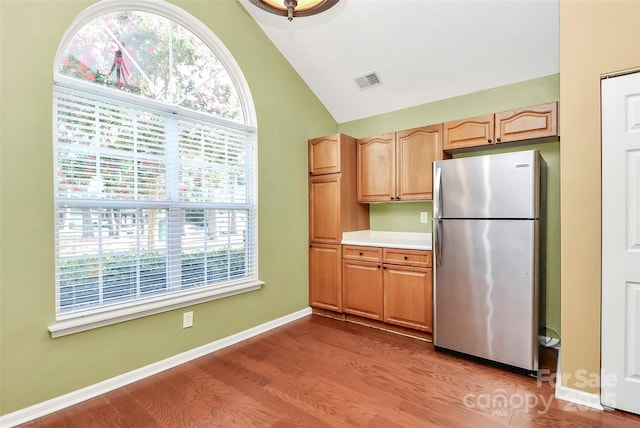 4580 Antelope Ln, Charlotte, NC 28269 - kitchen featuring freestanding refrigerator, wood finished floors, healthy amount of natural light, high vaulted ceiling, and light countertops