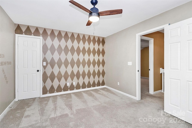 4580 Antelope Ln, Charlotte, NC 28269 - spare room featuring an accent wall, a ceiling fan, and carpet floors