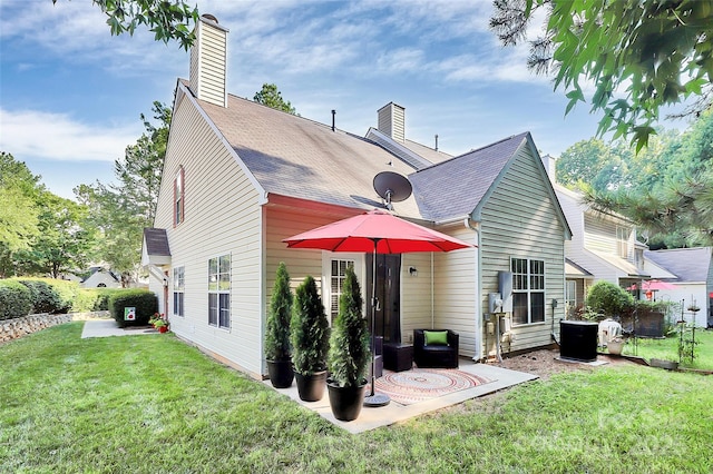 4580 Antelope Ln, Charlotte, NC 28269 - back of property featuring a chimney, a lawn, and a patio