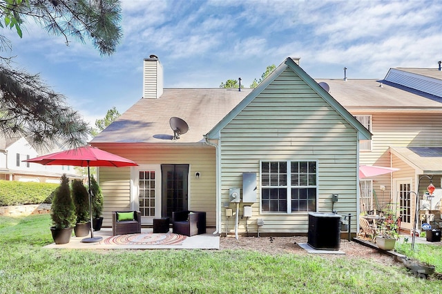 4580 Antelope Ln, Charlotte, NC 28269 - rear view of house featuring a lawn, a patio, and a chimney