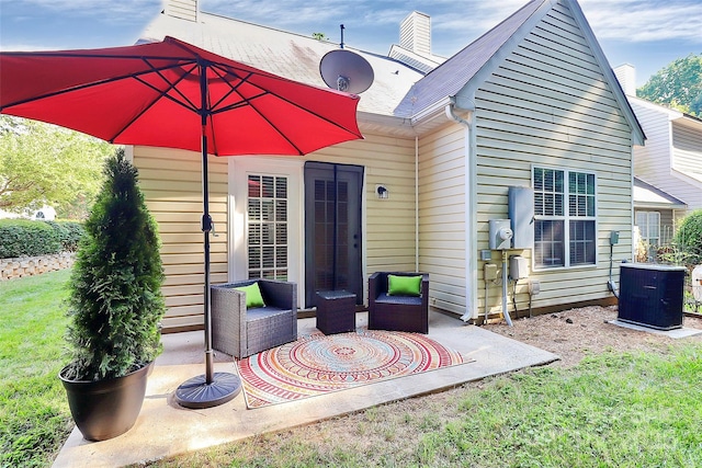 4580 Antelope Ln, Charlotte, NC 28269 - rear view of house with a patio area, a chimney, and a lawn