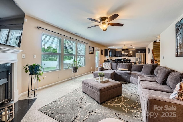 10920 Dapple Grey Ln, Charlotte, NC 28213 - living area with a high end fireplace, carpet flooring, a ceiling fan, and stairs