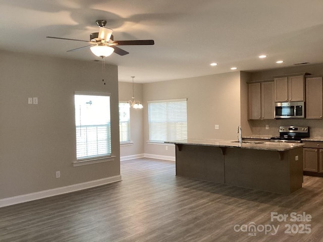 5126 Rocky River Crossing Rd, Harrisburg, NC 28075 - kitchen with stainless steel appliances, a kitchen bar, recessed lighting, dark wood-style floors, and healthy amount of natural light