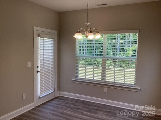 5126 Rocky River Crossing Rd, Harrisburg, NC 28075 - unfurnished dining area featuring a chandelier and dark wood finished floors