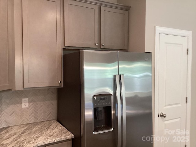 5126 Rocky River Crossing Rd, Harrisburg, NC 28075 - kitchen featuring stainless steel refrigerator with ice dispenser, gray cabinets, backsplash, and light stone countertops