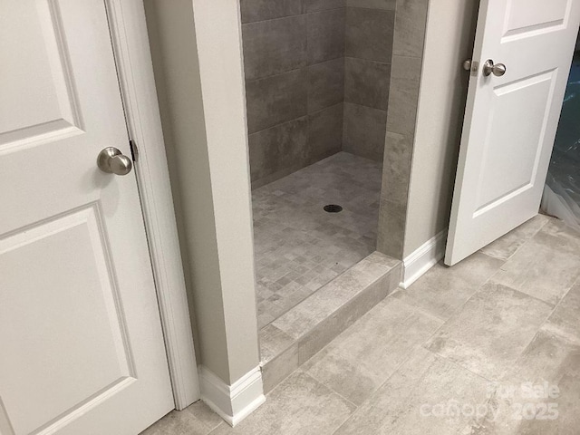 5126 Rocky River Crossing Rd, Harrisburg, NC 28075 - full bathroom featuring a tile shower and baseboards
