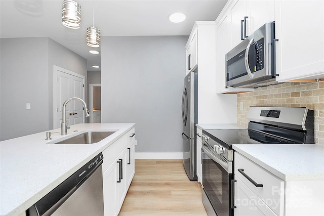 226 N Columbia Ave, Rock Hill, SC 29730 - kitchen featuring stainless steel appliances, decorative backsplash, pendant lighting, white cabinetry, and light wood-style floors