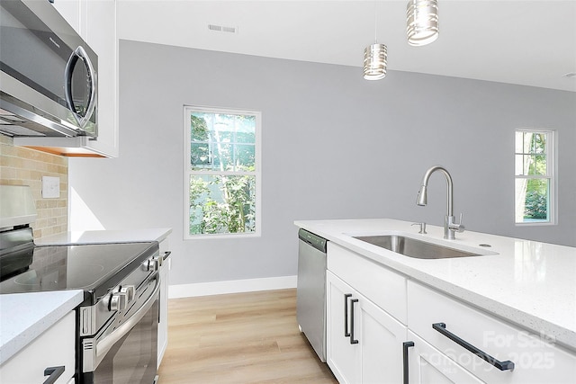 226 N Columbia Ave, Rock Hill, SC 29730 - kitchen featuring appliances with stainless steel finishes, tasteful backsplash, healthy amount of natural light, and decorative light fixtures