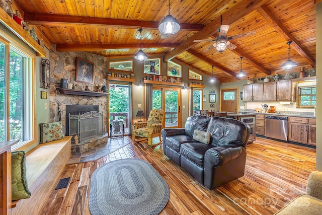 821 Old Chestnut Mountain Rd, Newland, NC 28645 - living room with wooden ceiling, light wood finished floors, a stone fireplace, and a ceiling fan