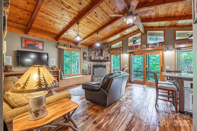 821 Old Chestnut Mountain Rd, Newland, NC 28645 - living area with a stone fireplace, a wooden ceiling with exposed beams, hardwood / wood-style flooring, a ceiling fan, and high vaulted ceiling