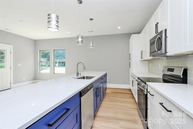 5516 Old York Rd, Rock Hill, SC 29732 - kitchen featuring appliances with stainless steel finishes, blue cabinetry, white cabinets, decorative backsplash, and decorative light fixtures
