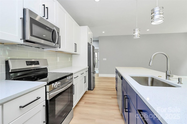 5516 Old York Rd, Rock Hill, SC 29732 - kitchen featuring appliances with stainless steel finishes, backsplash, white cabinets, pendant lighting, and light wood finished floors