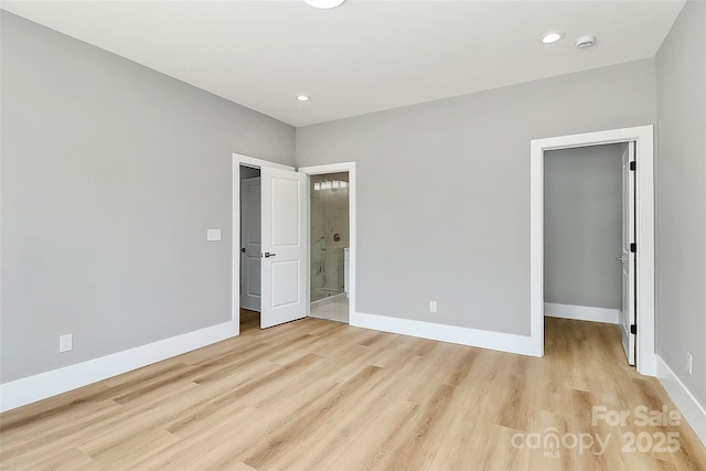 5516 Old York Rd, Rock Hill, SC 29732 - unfurnished bedroom featuring a spacious closet, light wood-style flooring, connected bathroom, recessed lighting, and a closet