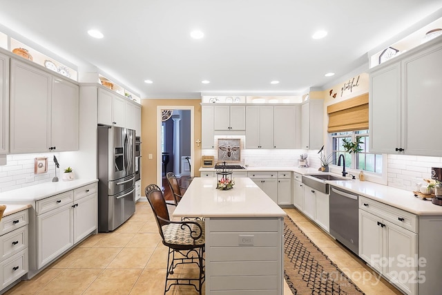 15933 Glen Miro Dr, Huntersville, NC 28078 - kitchen with appliances with stainless steel finishes, decorative backsplash, a breakfast bar area, and recessed lighting