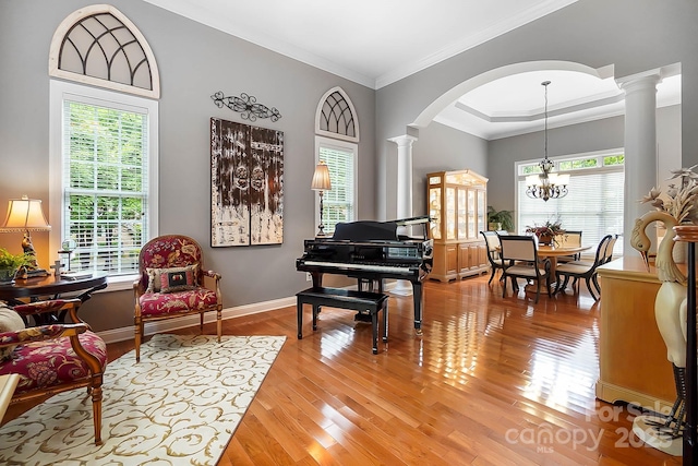 15933 Glen Miro Dr, Huntersville, NC 28078 - living area with ornate columns, arched walkways, healthy amount of natural light, light wood finished floors, and ornamental molding