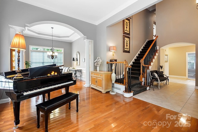 15933 Glen Miro Dr, Huntersville, NC 28078 - entryway with arched walkways, light wood-style flooring, crown molding, a chandelier, and healthy amount of natural light