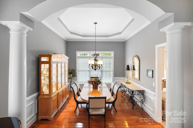 15933 Glen Miro Dr, Huntersville, NC 28078 - dining space featuring wood finished floors, a raised ceiling, a decorative wall, wainscoting, and a chandelier