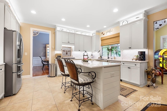 15933 Glen Miro Dr, Huntersville, NC 28078 - kitchen featuring stainless steel fridge, light countertops, decorative backsplash, a kitchen breakfast bar, and recessed lighting